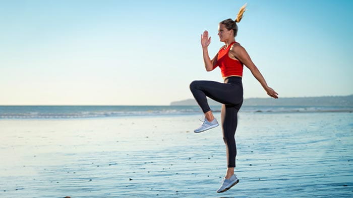 Woman working out on the beach