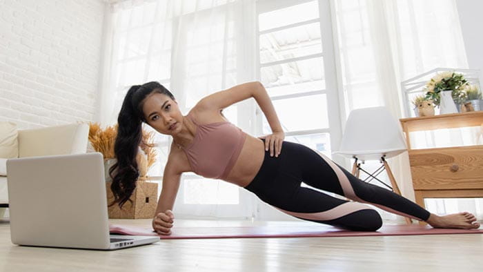 Woman working out in front of her laptop