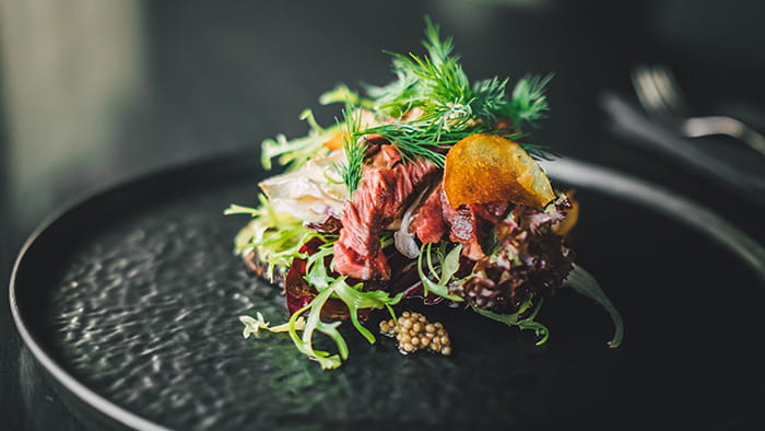 A fine dining steak salad with caviar