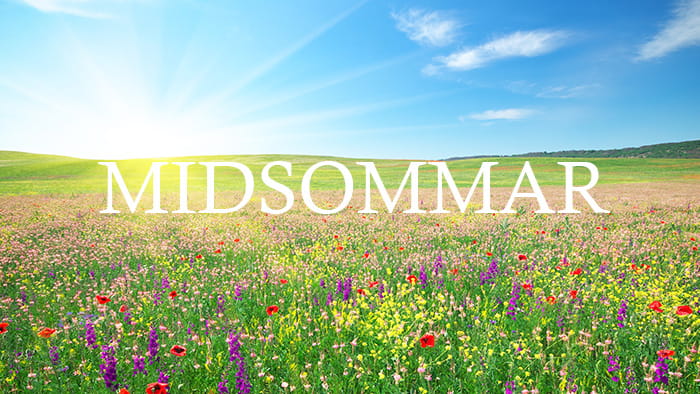A field of flowers with Midsommar written on it