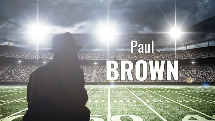 A silhouette representing Paul Brown in a football stadium