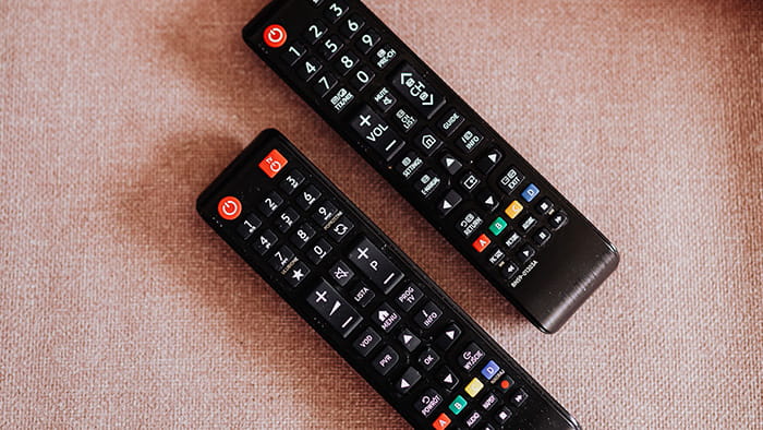 Multiple remote controls bound together with rubber bands