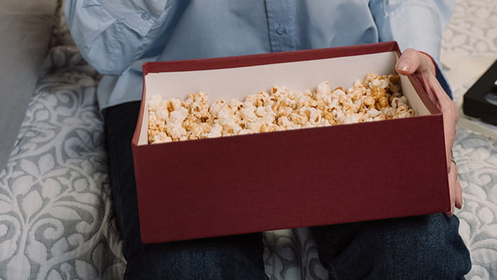 A box filled with popcorn surrounding fragile items