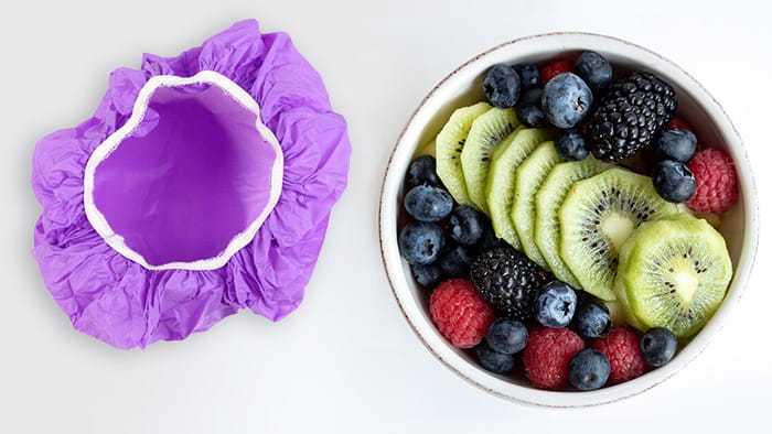 A bowl of food covered with a shower cap to keep it fresh