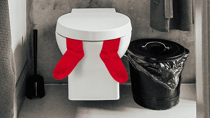 A toilet seat covered with socks to keep it warm