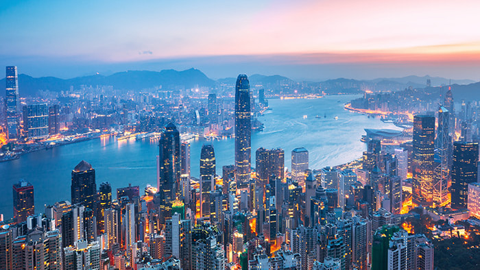 The mesmerizing Hong Kong skyline illuminated at night, reflecting over the harbor.