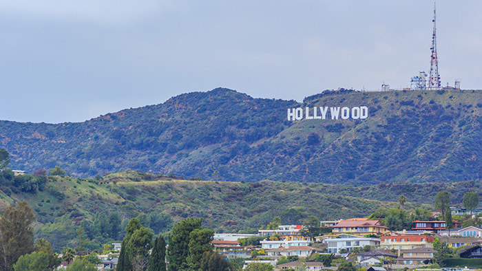 The iconic Hollywood sign with the sprawling city of Los Angeles in the backdrop.