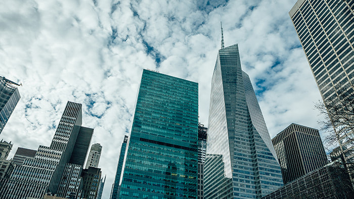 The iconic New York City skyline with skyscrapers touching the clouds.