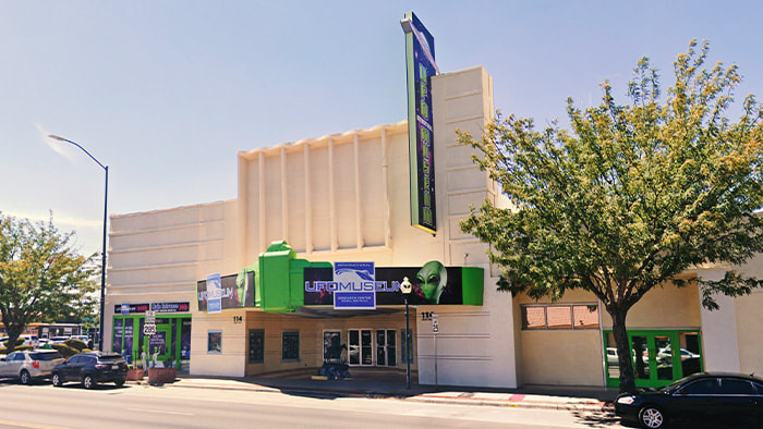 Exterior view of the Roswell UFO Museum in Roswell, New Mexico, with UFO-themed decorations and exhibits, including a model of a flying saucer